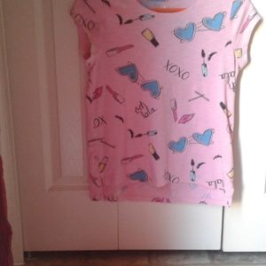 A short sleeve tee with makeup designs and words.